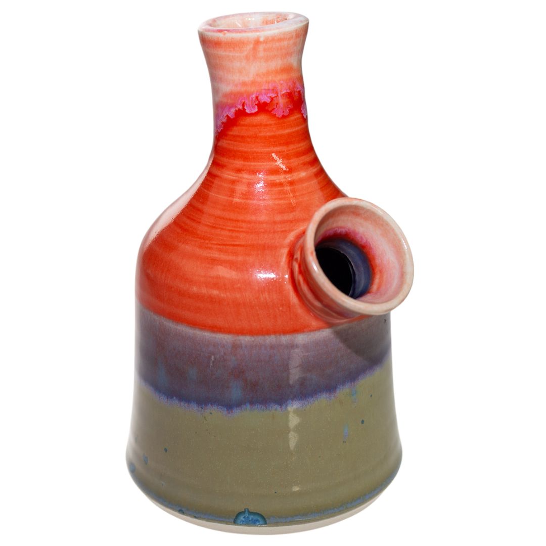 This is the front view of a ceramic water pipe created by Morghan Gray that has a multitude of bright quality colors. It features a wide body and mouth piece for bigger and smoother hits. - Up N Smoke.