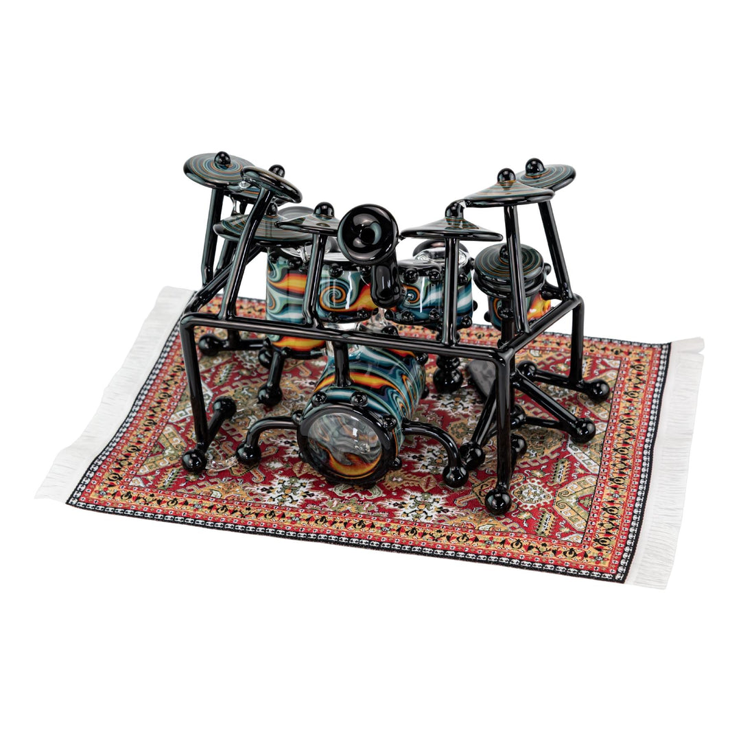 "AJ Roberts Wig Wag Drum Set on the intricate mini rug placemat on a white background," - Up N Smoke.