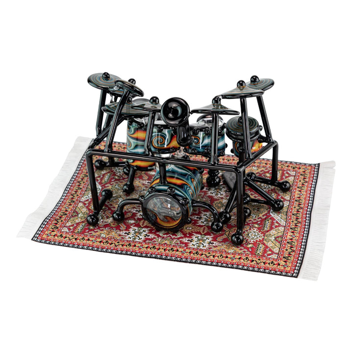 "AJ Roberts Wig Wag Drum Set on the intricate mini rug placemat on a white background," - Up N Smoke.