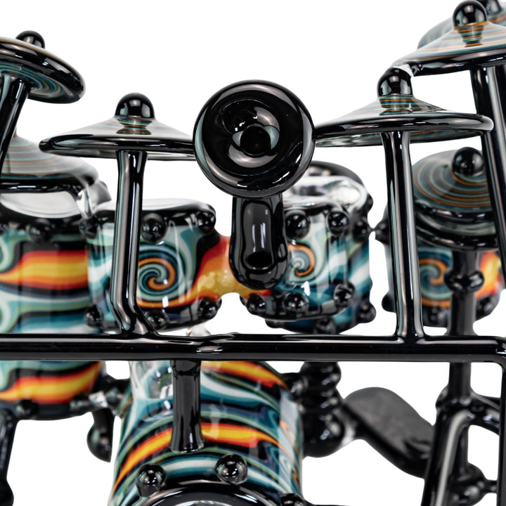 "Close-up of the mouthpiece to an AJ Roberts Wig Wag Drum Set on a white background," - Up N Smoke.
