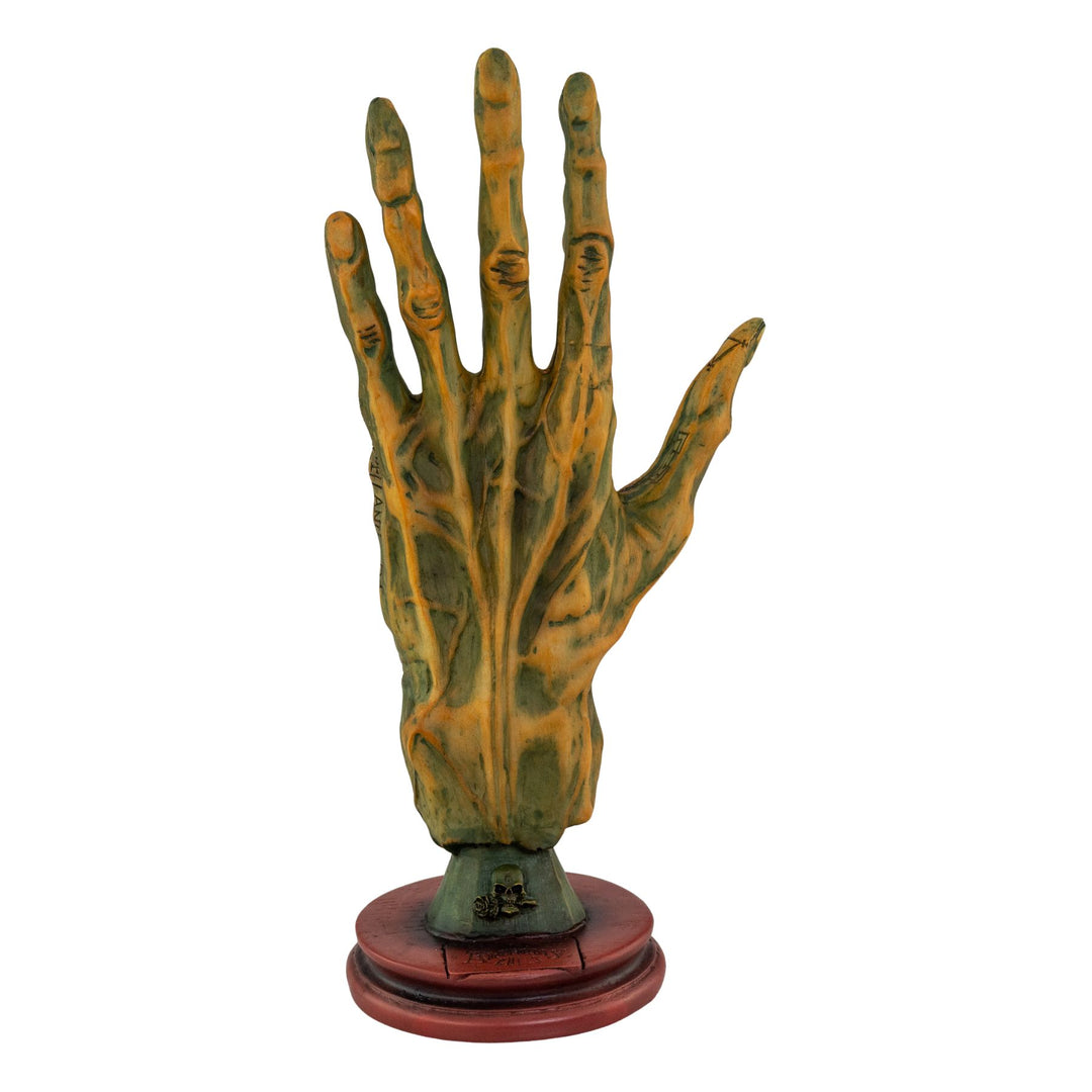 "Decorative hand sculpture with a wooden base on a white background," - Up N Smoke.