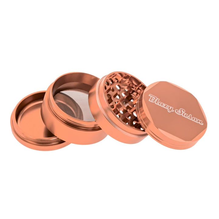 Blazy Susan 4 Piece Rose Gold Grinder showcasing different compartments displayed on a white background - Up N Smoke