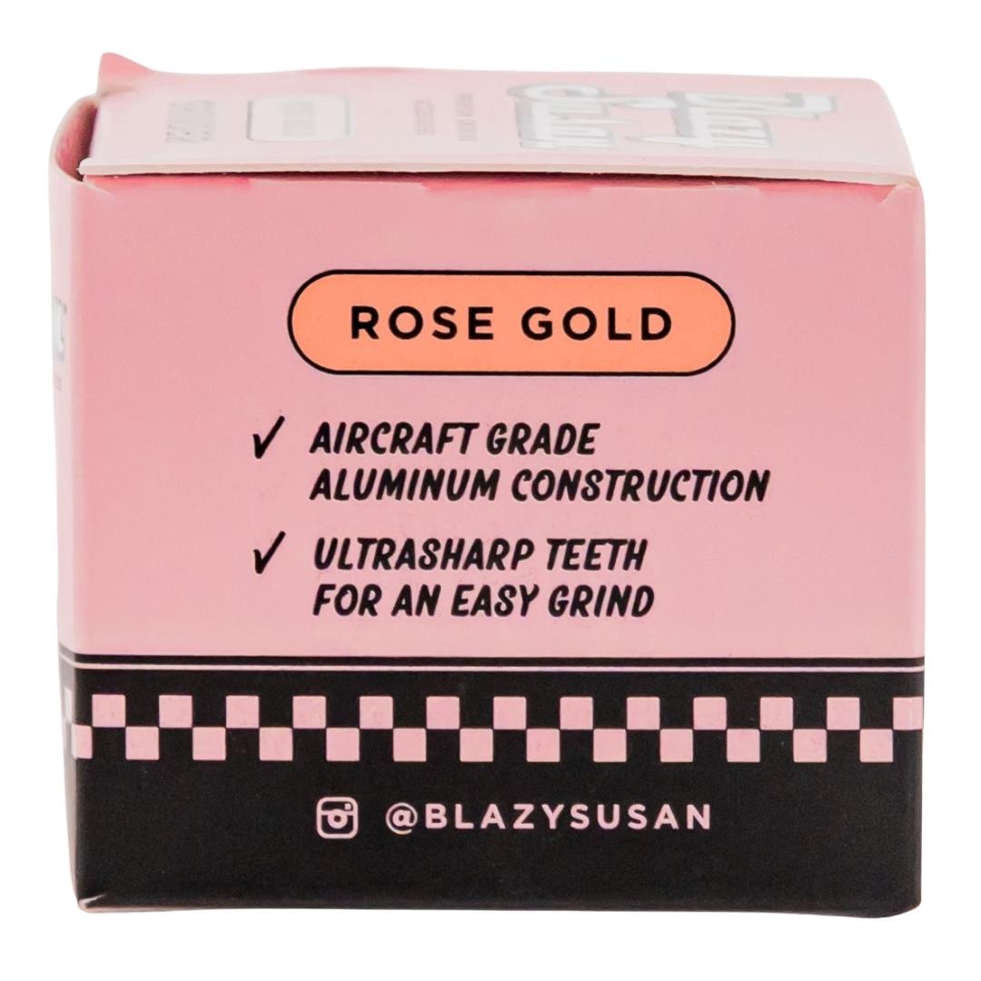 Blazy Susan 4 Piece Rose Gold Grinder showcasing side of packaging displayed on a white background - Up N Smoke