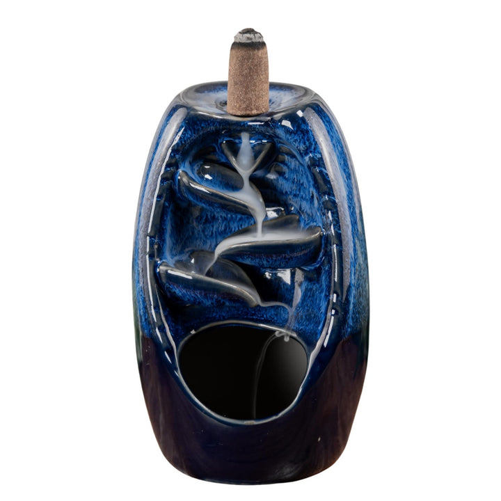 "Blue Ceramic Incense Burner with smoke streaming down the bodice on a white background," - Up N Smoke.