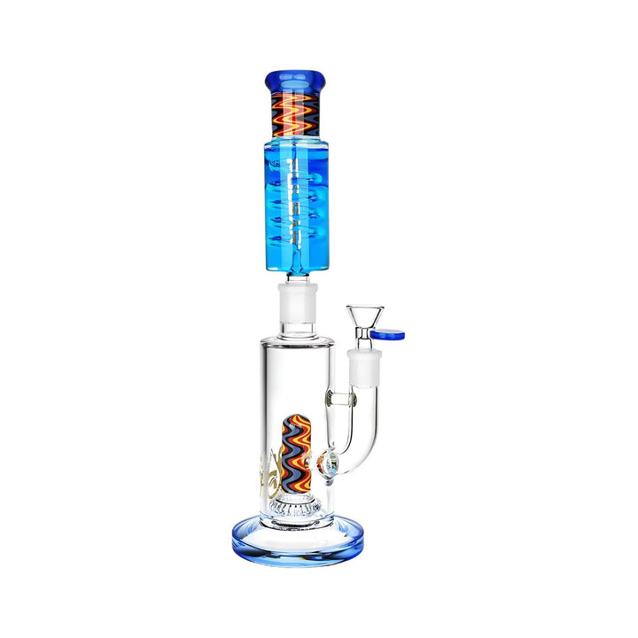 "Close-up of the Wig Wag Glycerin Stacker Bong from Pulsar Vaporizers. The bong features a multi-chamber design with a vibrant, wig-wag pattern in a mix of colors. It includes a glycerin-filled chamber for cooling, enhancing the smoking experience. The piece has a sleek, modern look with a clear glass body and intricate details." - Up N Smoke.