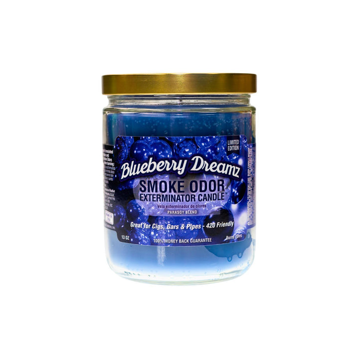  "Close-up of the Blueberry Dreamz Smoke Odor Exterminator Candle. The jar features a label with a dreamy design in shades of blue, showcasing blueberry illustrations. The candle inside has a rich, deep blue wax, and the label emphasizes its fruity blueberry fragrance, ideal for eliminating smoke and other odors." - Up N Smoke.