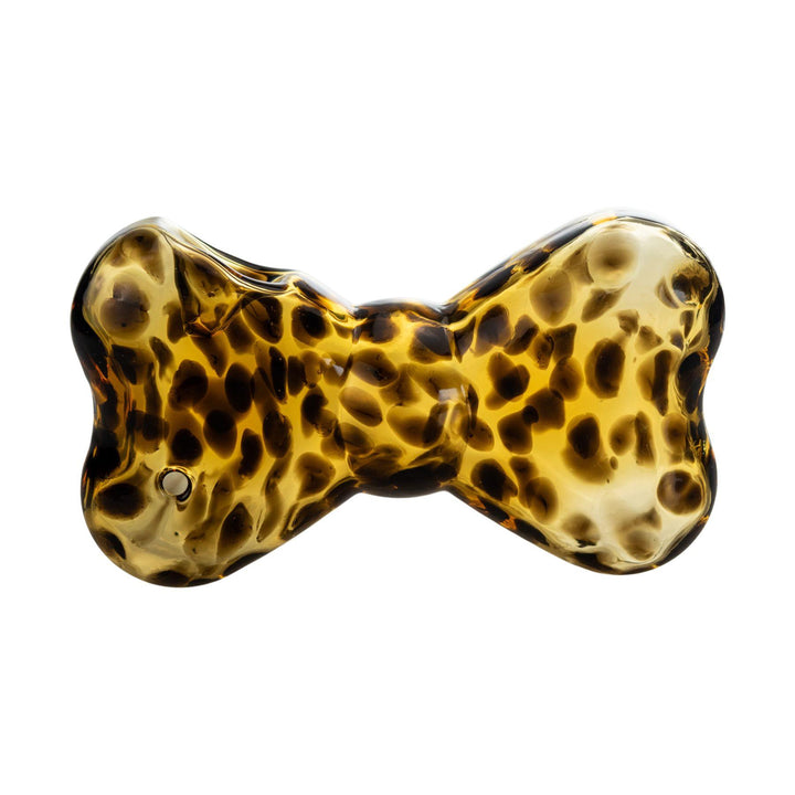 "Tortoise-shell patterned glass hand pipe shaped like a bow, featuring a classic leopard print design. This hand pipe was designed by Go Easy, a queer and woman-owned business based out of Texas." - Up N Smoke.