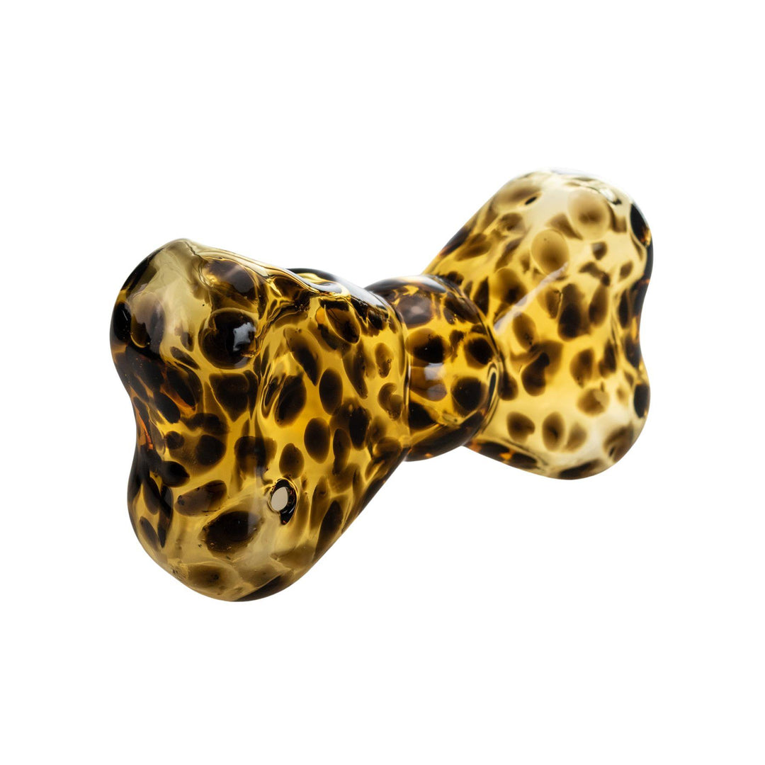 "Tortoise-shell patterned glass hand pipe shaped like a bow, featuring a classic leopard print design. This hand pipe was designed by Go Easy, a queer and woman-owned business based out of Texas." - Up N Smoke.