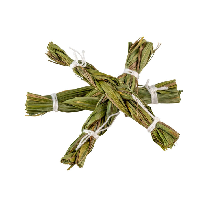 "Bundled green Sweet Grass tied with white string on a white background," - Up N Smoke.