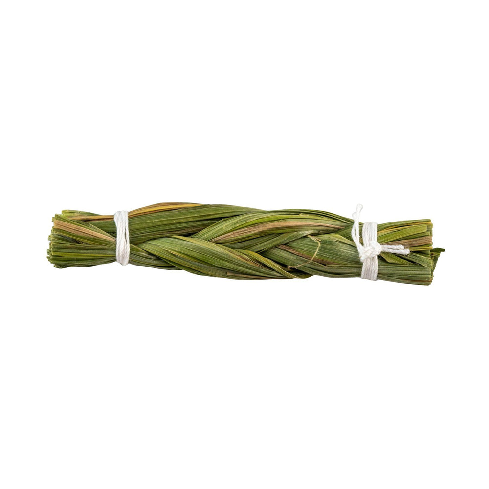 "Bundled green herbs tied with a white string on a white background," - Up N Smoke.