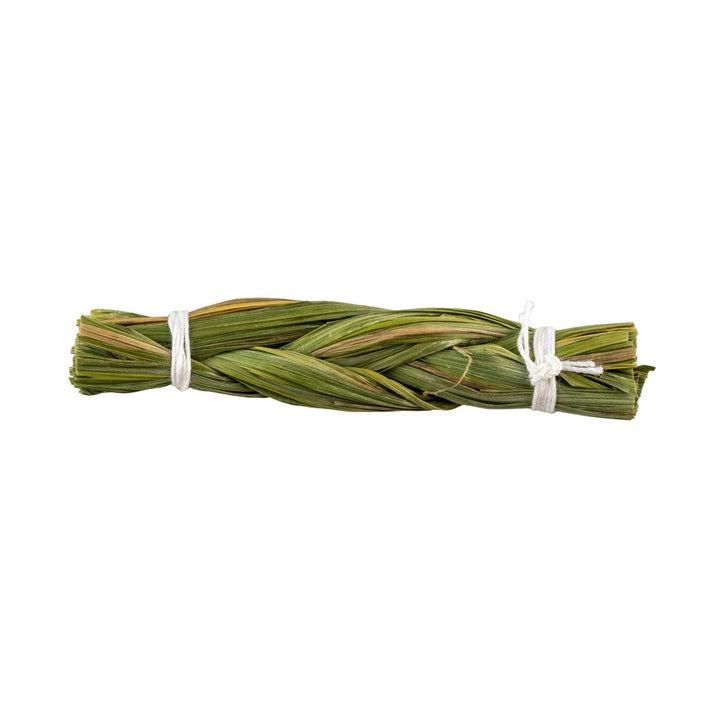 "Bundled green herbs tied with a white string on a white background," - Up N Smoke.