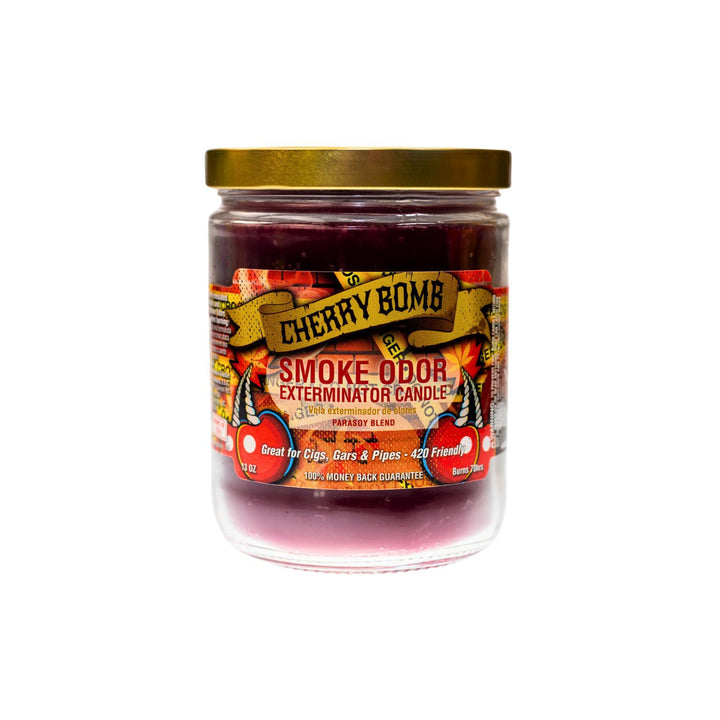 "Close-up of the Cherry Bomb Smoke Odor Exterminator Candle. The jar features a bold, eye-catching label with vibrant cherry and explosive graphic designs. The candle inside has a deep, dark purple wax, and the label emphasizes its rich cherry fragrance blend, perfect for eliminating smoke and other odors." - Up N Smoke.