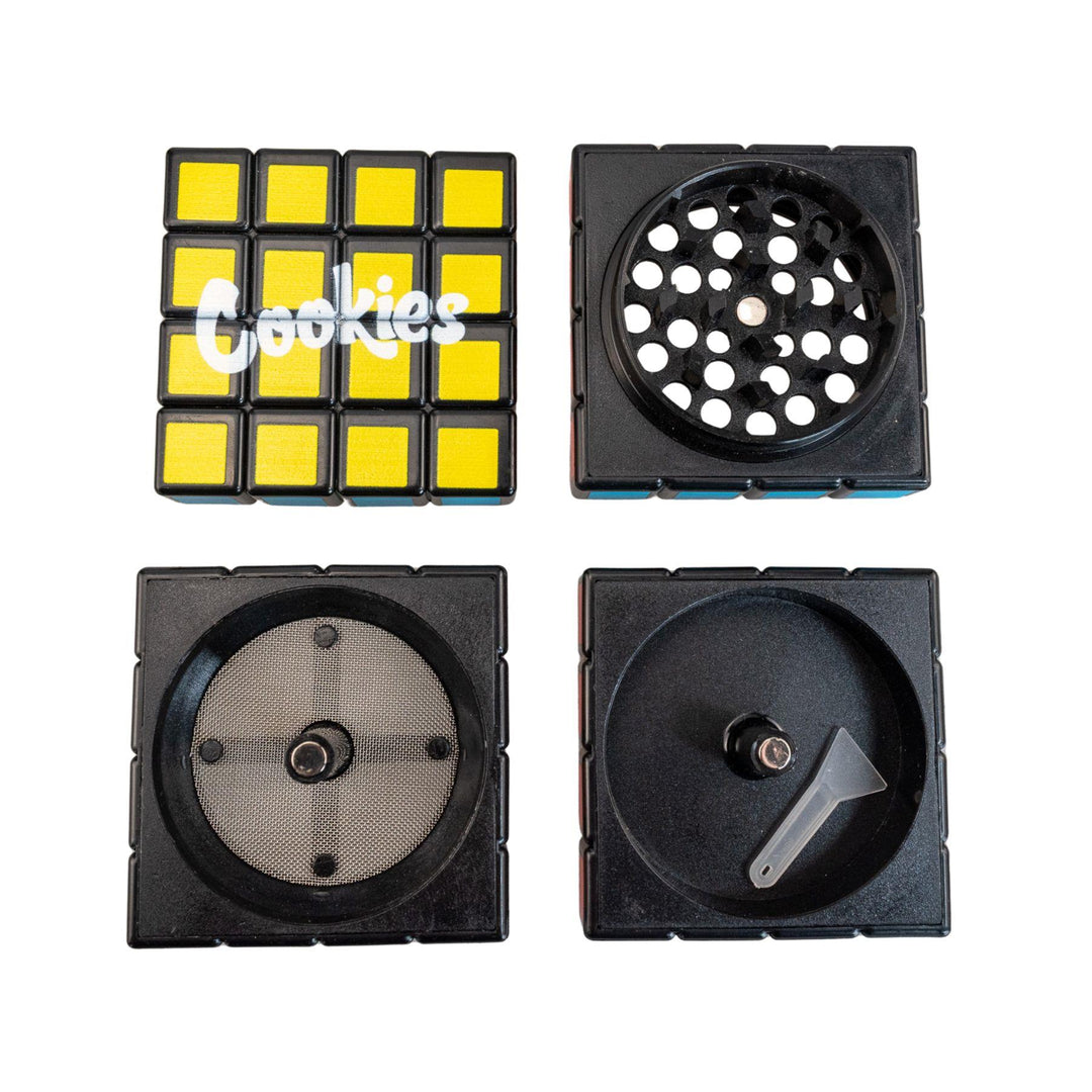 "Cookies Rubik's Cube Grinder with all four compartments separated on a white background," - Up N Smoke.
