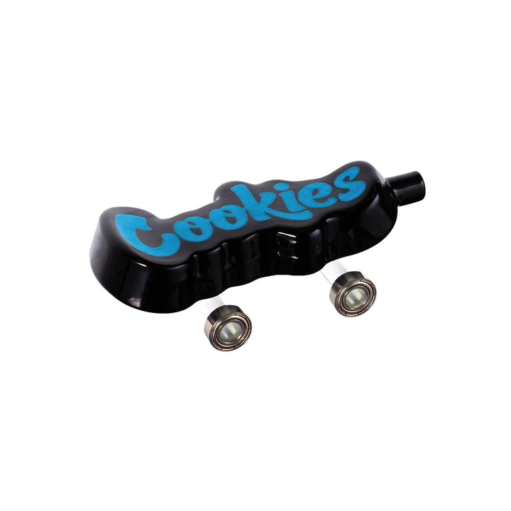 "Side photograph of a Cookies Toke Deck in black. This hand pipe is 4.25'' and features functional wheels, completing the skater aesthetic of its design. The bowl for flower is located underneath, and the mouth piece is at the front of the spoon." - Up N Smoke.