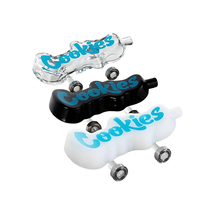 "Group photograph of three Cookies Toke Decks. This hand pipe is modeled after a skateboard, and comes with functional wheels! This piece comes in clear, black and white, and comes with a Santa Cruz Shredder grinder made out of hemp." - Up N Smoke.