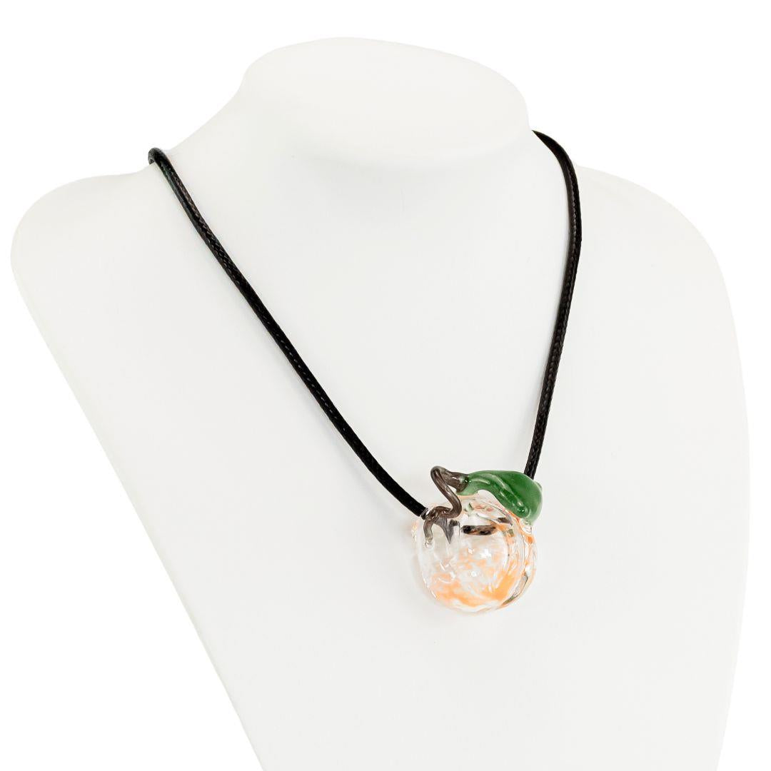 Dalik Glass Pumpkin Pendant displayed on a white background inluding necklace - Up N Smoke