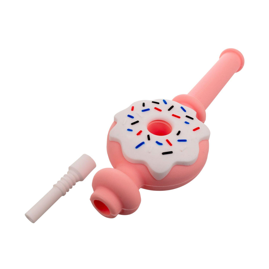 "Side angle of a pink and white Doughnut Silicone Nectar Collector with the ceramic tip outside the insert on a white background," - Up N Smoke.