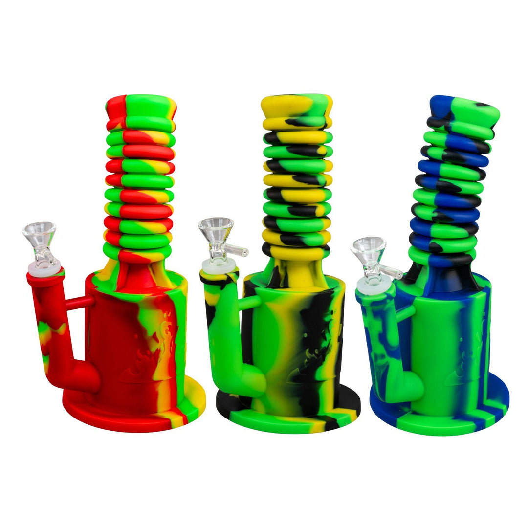 "Three colorful silicone smoking devices with glass bowls on a white background," - Up N Smoke.