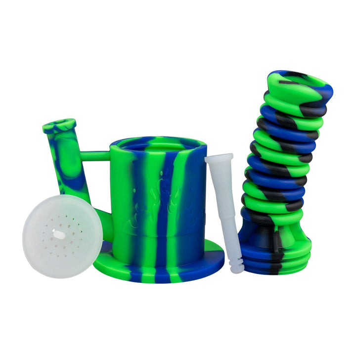 "Green and blue Expandable Silicone Water Pipe with all its compartments separated on a white background," - Up N Smoke. 