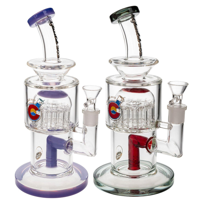 "Two Glass Lab 303 Tree Perc Water Pipes in the variations Smoky and Wisteria on a white background," - Up N Smoke.