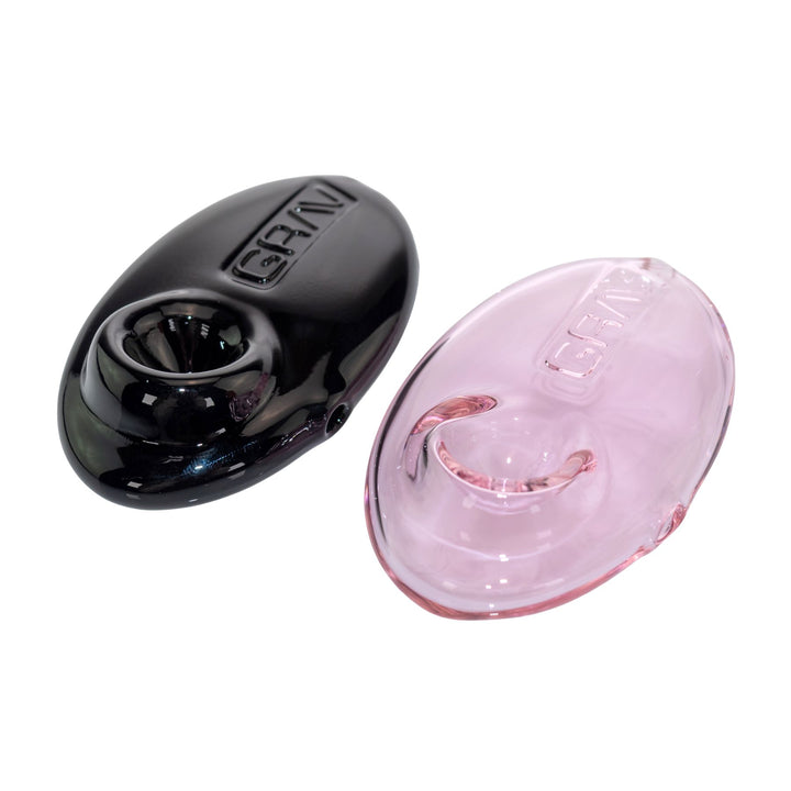 "Two Grav Labs Pebble Spoons in the color variations black and pink on a white background," - Up N Smoke.