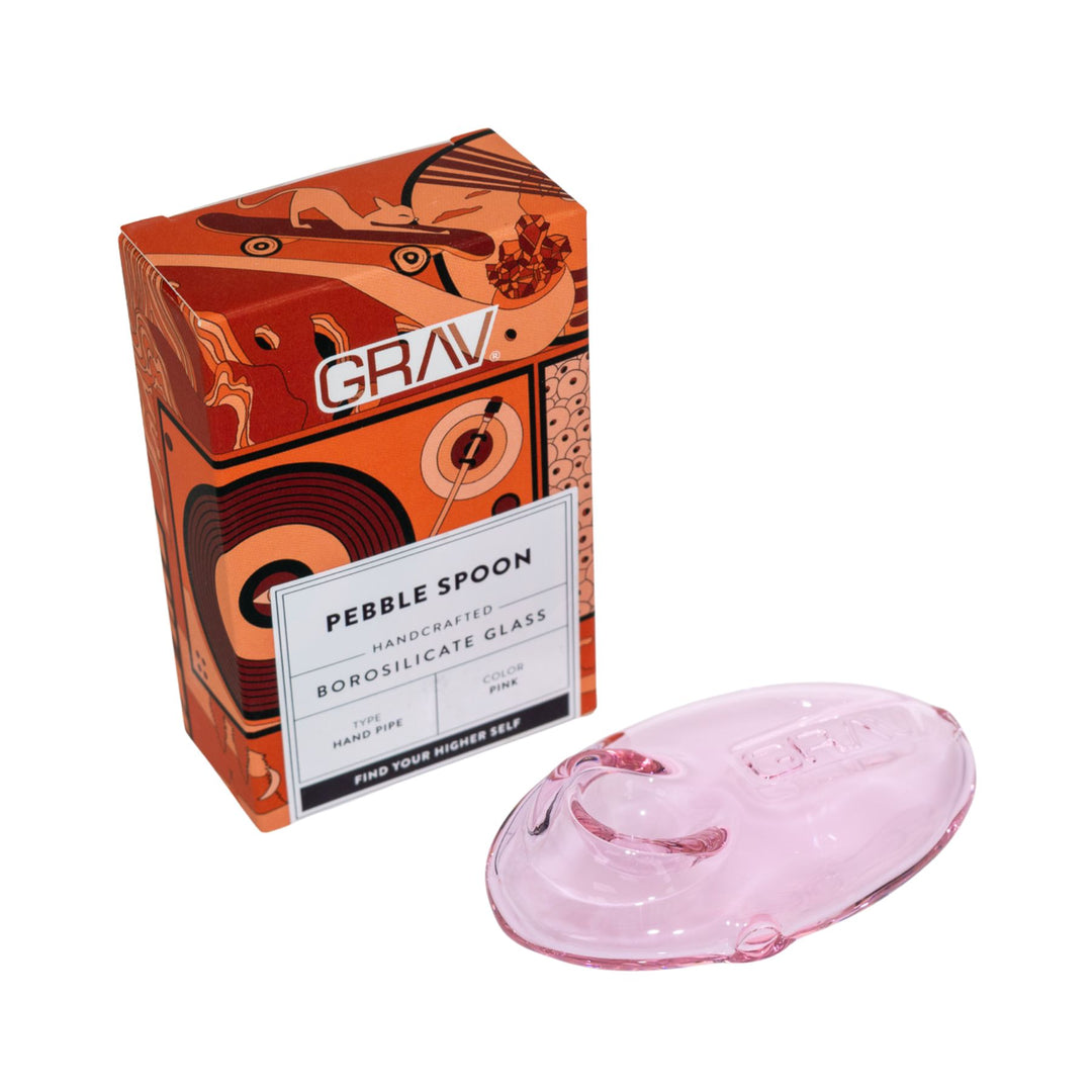 "Pink pebble spoon next to its packaging with 'GRAV' branding on a white background," - Up N Smoke.