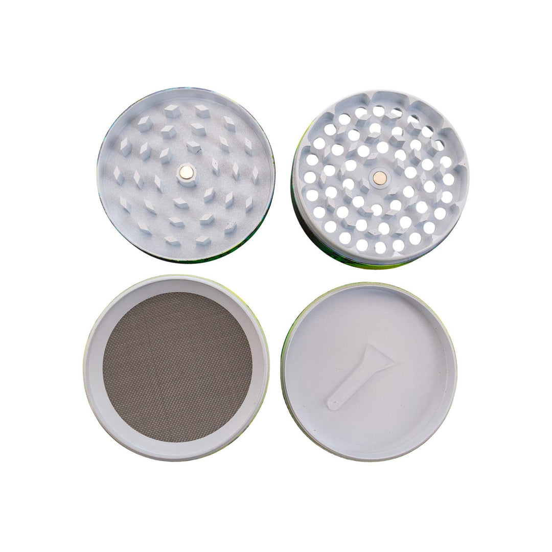 "Four-piece Green Skull Grinder with all compartments laid out on a white background," - Up N Smoke.