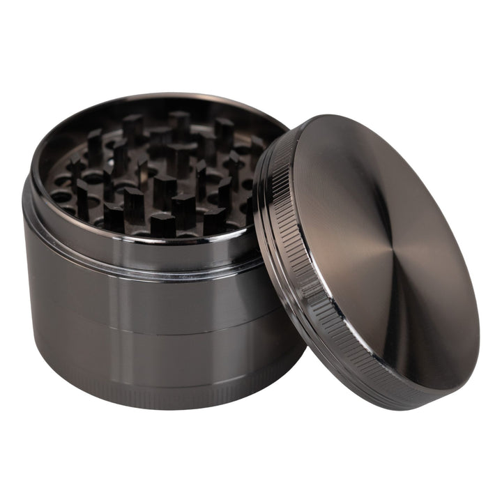 "Gunmetal Classic 4-Piece Grinder with its lid propped up against the rest of the tool," - Up N Smoke.