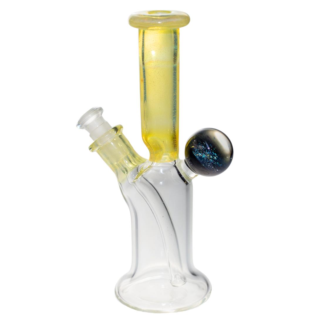 Left side view of a yellow Jack Glass rig. This piece features a unique marble on the back that is packed with dimension and color. - Up N Smoke.