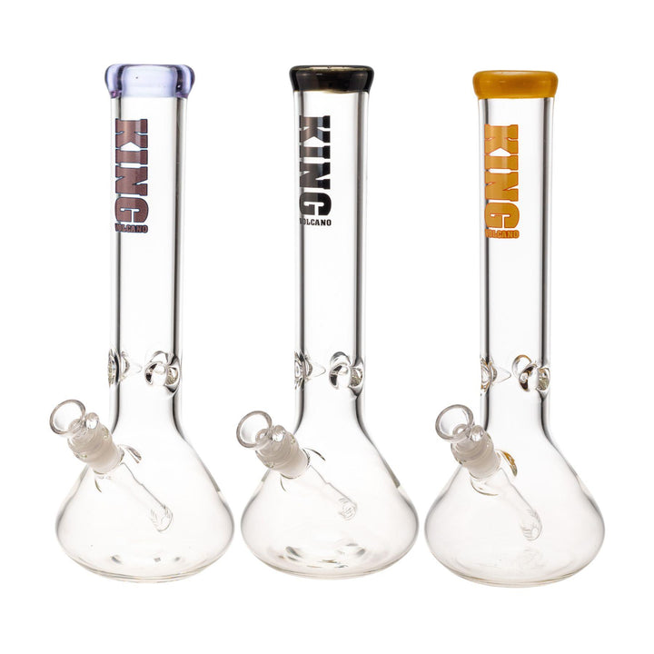 "Group of three King Volcano 50mmx15'' Beakers in the color variations purple, black, and yellow, on a white background," - Up N Smoke.