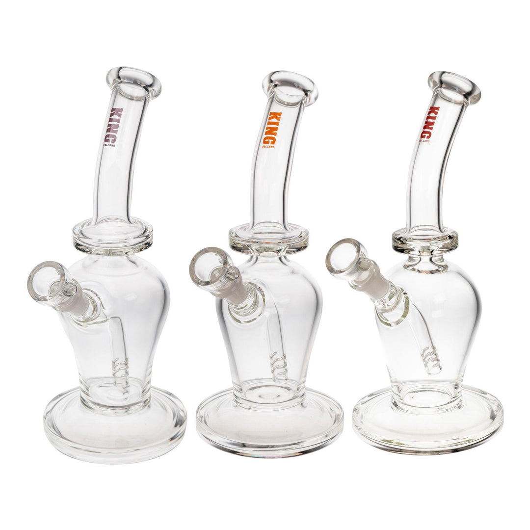 "Group of three King Volcano 50mmx10in Fixed Flare Bubblers in the colors purple, orange, and red, on a white background," - Up N Smoke.