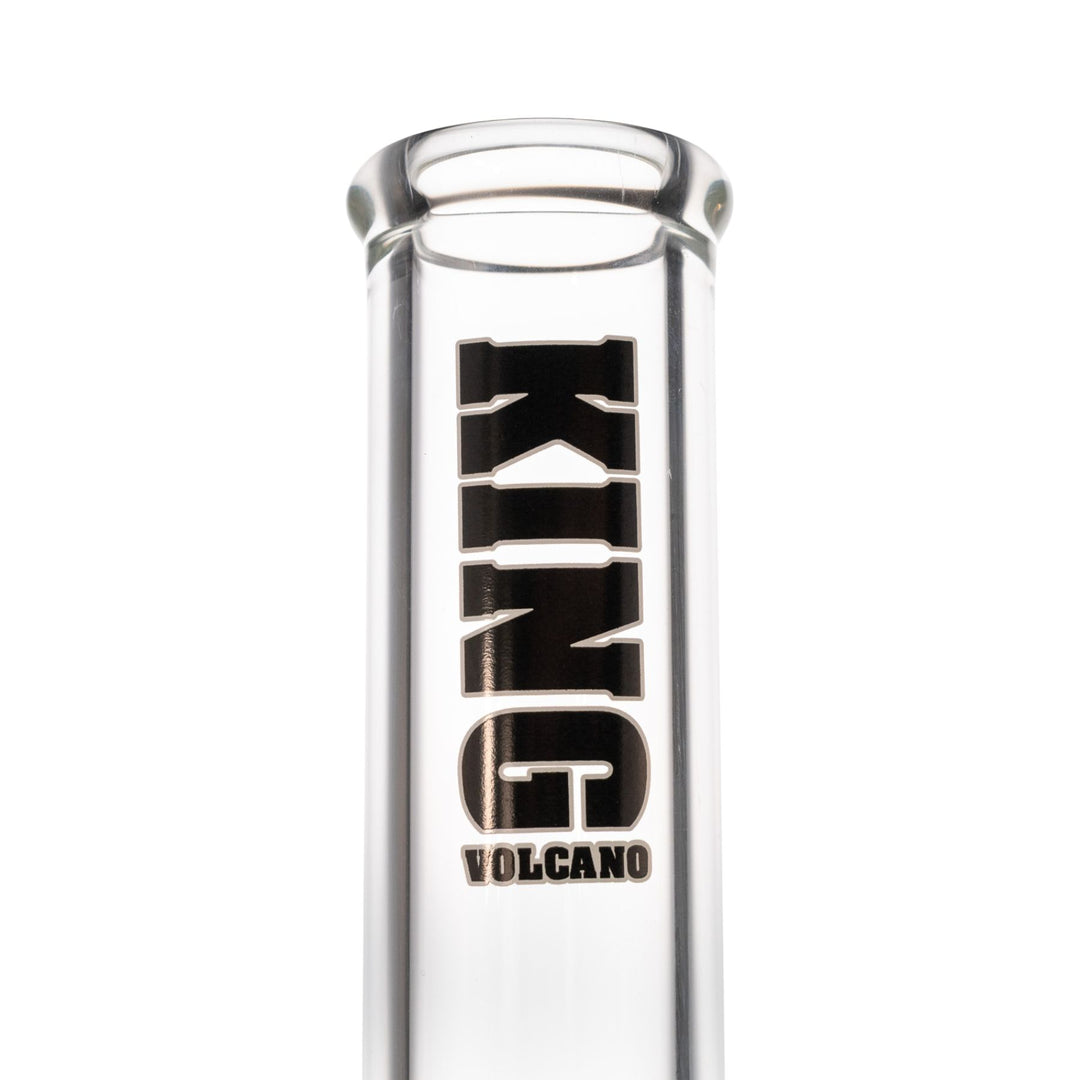"Close-up view of a black King Volcano logo on a clear beaker against a white background," - Up N Smoke.