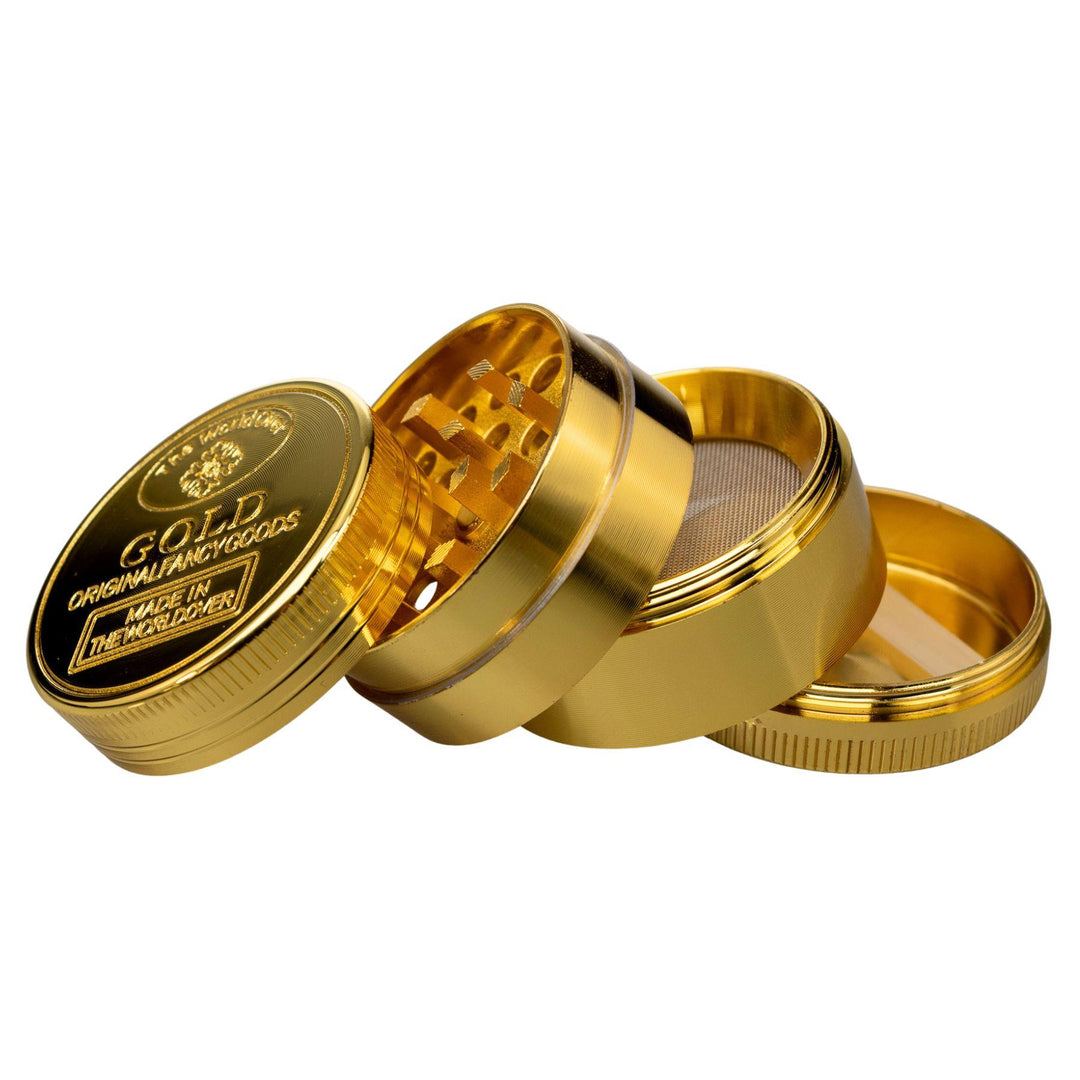 "Four-Piece Mini Gold Grinder splayed out showcasing all compartments on a white background," - Up N Smoke.