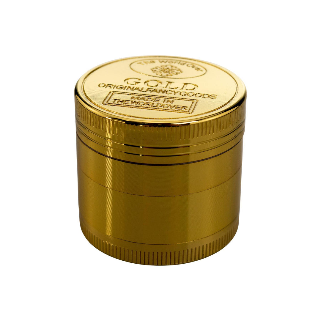 "Mini Four-Piece Gold Grinder with engraving on the top on a white background," - Up N Smoke.