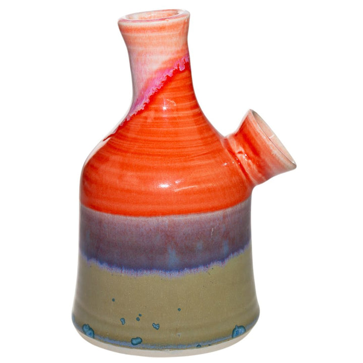This is the right side view of a ceramic water pipe created by Morghan Gray that has a multitude of bright quality colors. It features a wide body and mouth piece for bigger and smoother hits. - Up N Smoke.