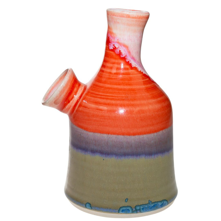 This is the left side view of a ceramic water pipe created by Morghan Gray that has a multitude of bright quality colors. It features a wide body and mouth piece for bigger and smoother hits. - Up N Smoke.