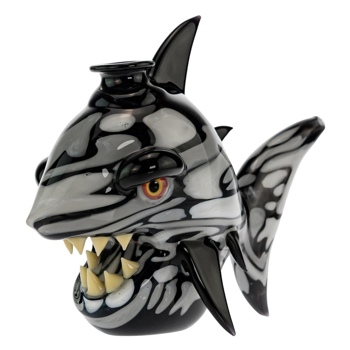 "Left side of a Niko Cray Heady Water Pipe that is black and white and has yellow teeth on a white background," - Up N Smoke.