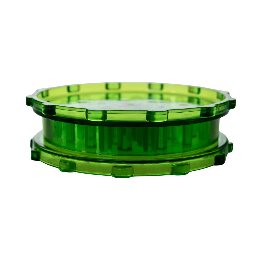"Closed green plastic 2-piece grinder on a white background," - Up N Smoke.
