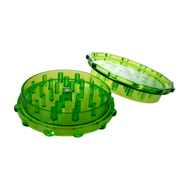 "Open green 2-piece plastic grinder on a white background," - Up N Smoke.