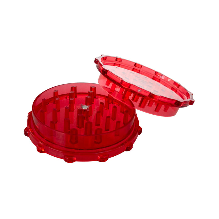 "Open red plastic 2-piece grinder on a white background," - Up N Smoke.