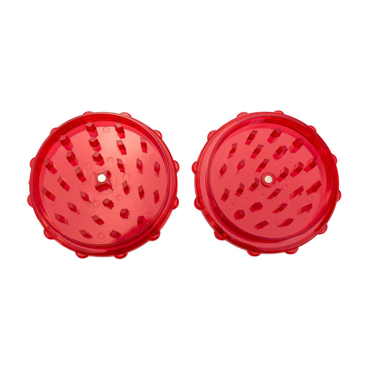 "Top-down view of a red plastic two-piece grinder on a white background," - Up N Smoke.