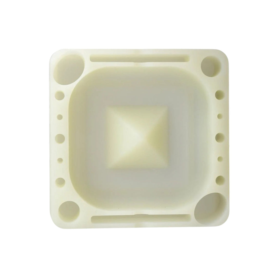 "A square silicone Pulsar Tap Tray in the color glow in the dark on a white background," - Up N Smoke.
