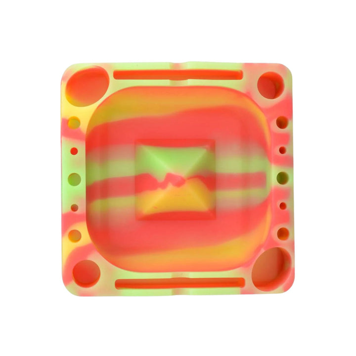 "A colorful Pulsar Tap Tray in the variation Rasta Glow. This ashtray glows in the dark and features stands to place your tools," - Up N Smoke.