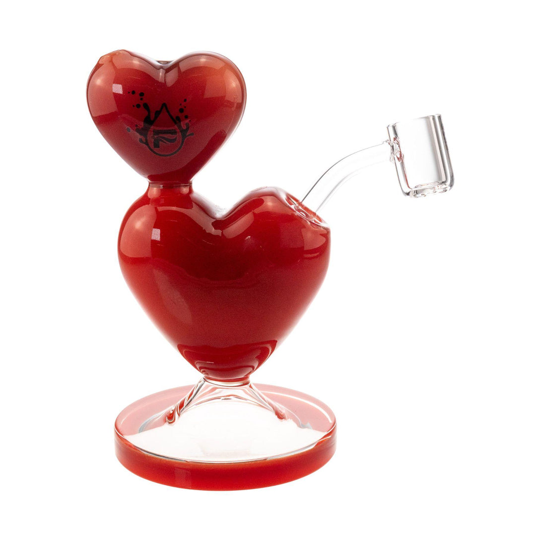 "Front of a Pulsar Double Heart Dab Rig on a white background," - Up N Smoke.