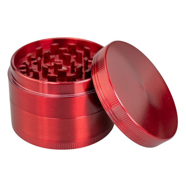 "Red Classic 4-Piece Grinder with its lid propped up against the rest of the tool," - Up N Smoke.
