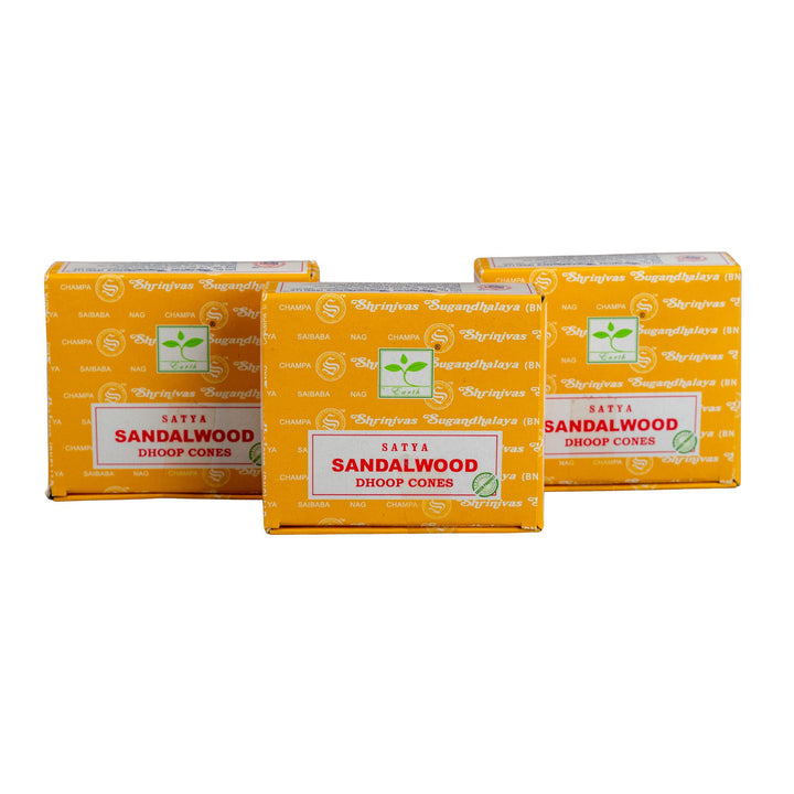 Three boxes of Satya Sandalwood Dhoop Cores on a white background