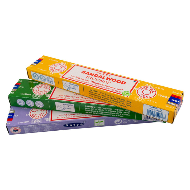 Three boxes of Satya incense sticks on a white background - Up N Smoke