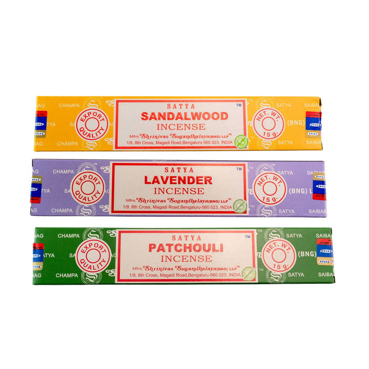 Three packages of Satya incense sticks in sandalwood, lavender, and patchouli scents on a white background - Up N Smoke
