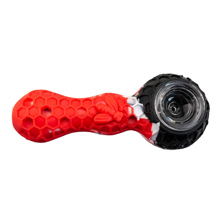 "A red and black Silicone Bee Spoon that comes with a metal tool and a storage compartment," - Up N Smoke.
