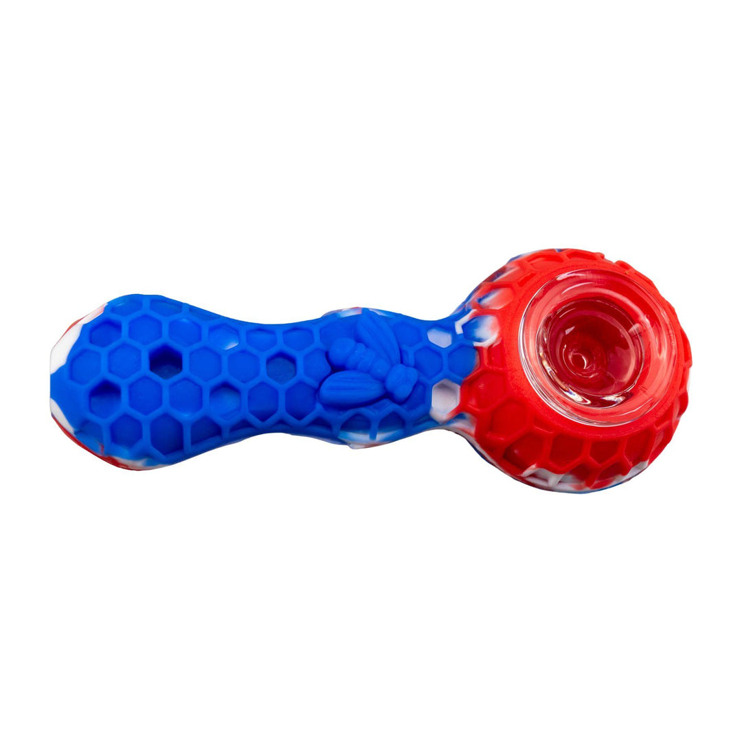 "A blue and red Silicone Bee Spoon that is embossed with a honeycomb-pattern design and adorned with a bee on the bodice," - Up N Smoke.